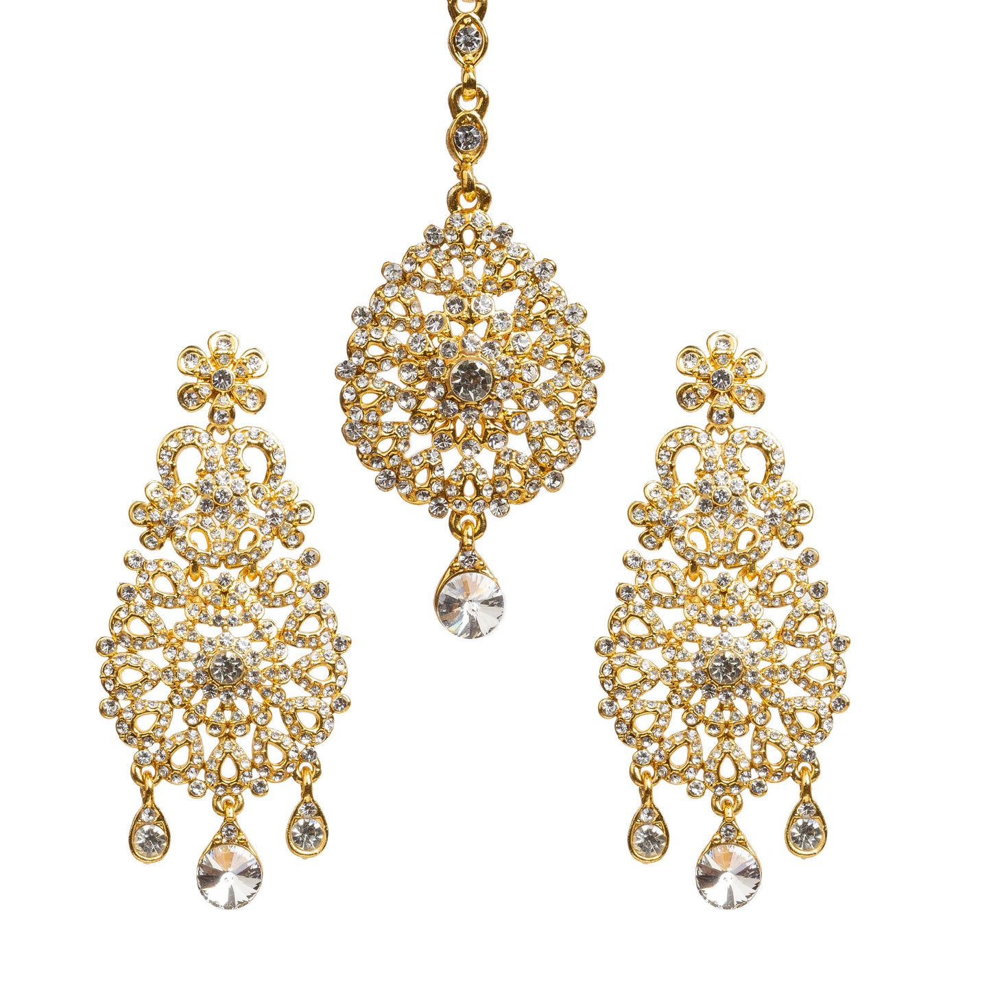 Bindhani gold-plated earrings and maang tikka set embellished with clear stones and sparkling crystal accents. The earrings feature a floral stud, intricate openwork filigree design with a central floral motif, and three dangling teardrop-shaped clear stones including a larger center teardrop stone. The matching maang tikka showcases a round floral design with detailed stone work, a central clear stone, and one dangling teardrop-shaped clear stone. Front view displayed on a white background.