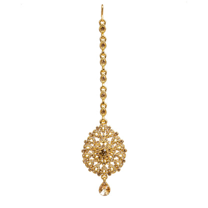 Bindhani gold-plated maang tikka featuring champagne-colored LCT stones with sparkling crystal accents. The tikka showcases an intricate round floral design with detailed openwork filigree, a central champagne LCT stone, and one dangling teardrop-shaped LCT stone. Front view displayed on a white background
