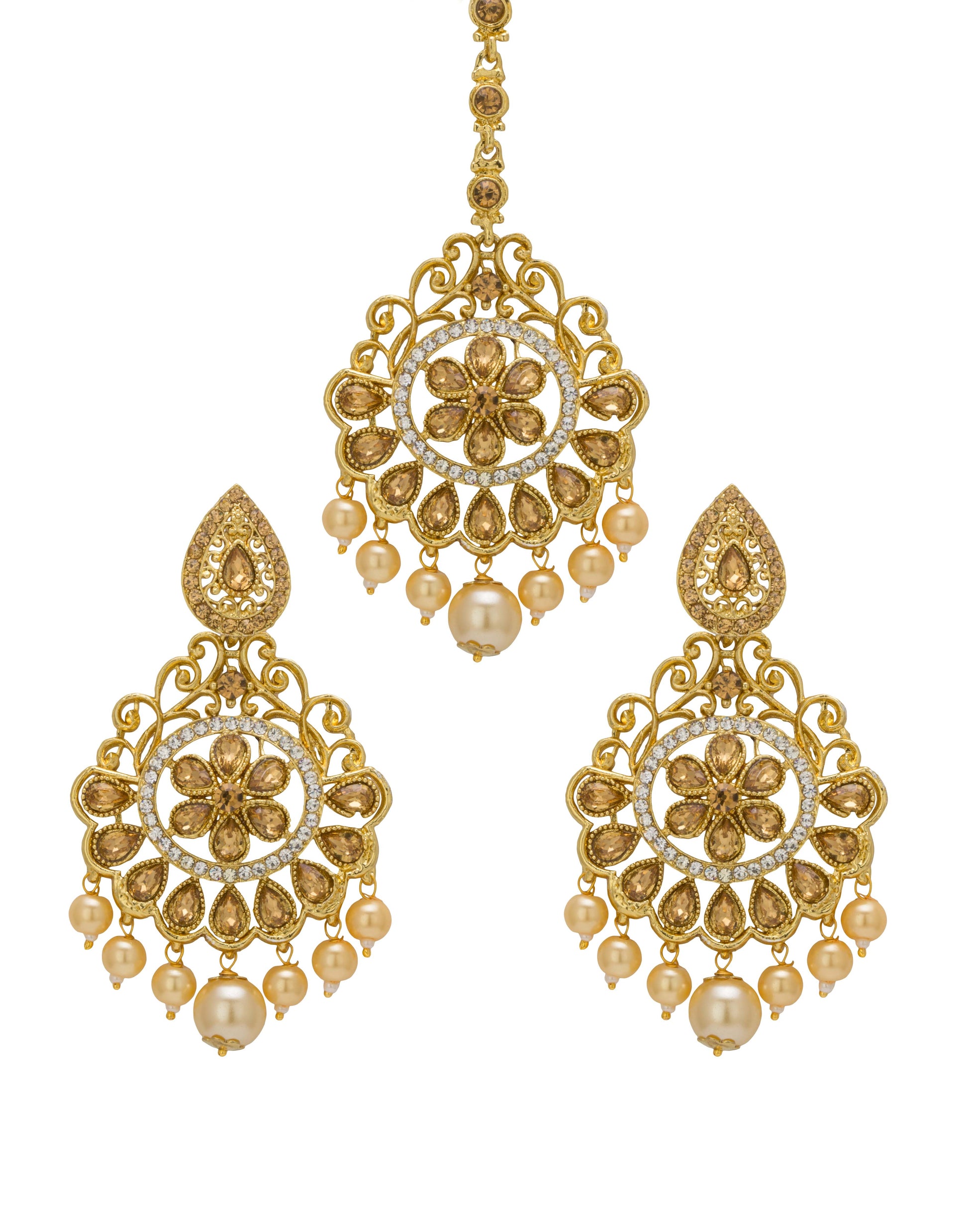 Bindhani gold-plated earrings and maang tikka set featuring antique gold-toned detailing, clear stones, and white pearl drop accents. The earrings showcase a floral center motif with intricate openwork filigree, teardrop-shaped stone detailing, and multiple pearl hanging drops with a larger center pearl. The matching maang tikka features a circular floral design with ornate filigree patterns and pearl drop embellishments. Front view displayed on a white background.