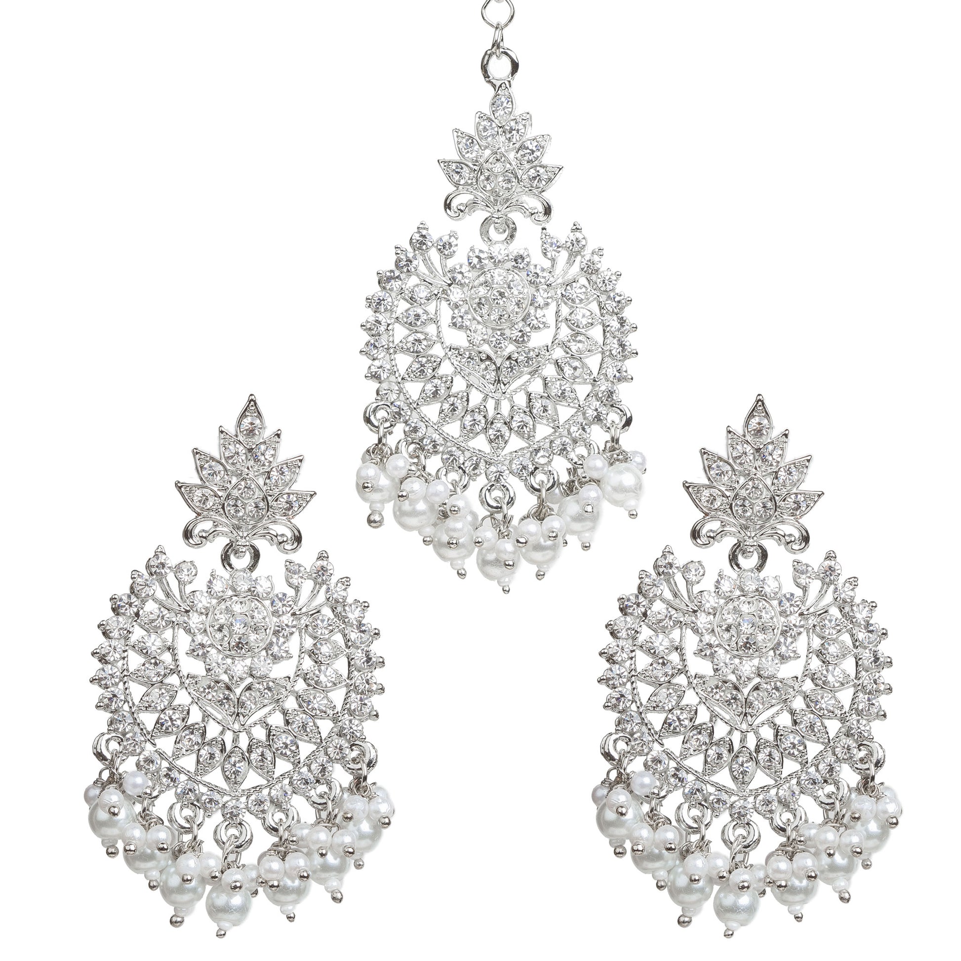 Bindhani silver-plated jewelry set featuring a matching maang tikka and statement earrings. The earrings showcase a leaf-shaped stud top, intricate openwork floral and geometric design embellished with clear stones, a central round stone, and white pearl bead tassels. The coordinating maang tikka features the same leaf and floral motif with dangling white pearl bead clusters. Front view displayed on a white background.