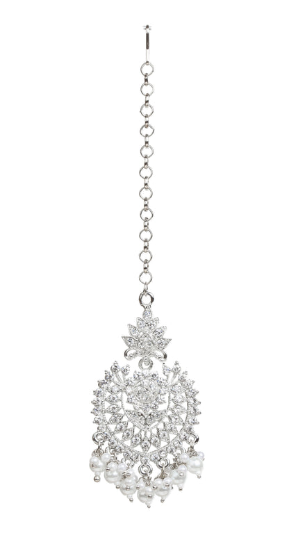 Bindhani silver-plated maang tikka featuring a leaf-shaped top with an intricate openwork floral and geometric design embellished with clear stones. The tikka is accented with a central round stone and finished with dangling white pearl bead clusters. Front view displayed on a white background.