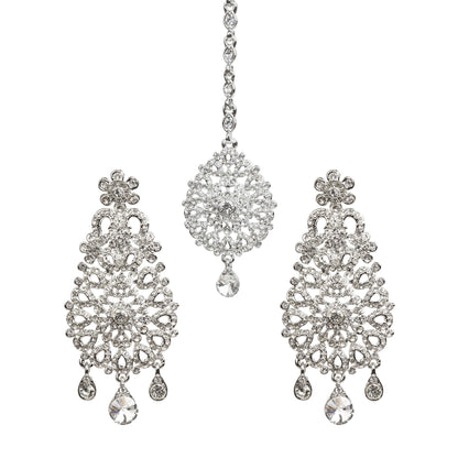 Bindhani silver-toned earrings and maang tikka set embellished with clear stones and intricate floral filigree detailing. The earrings feature a floral stud, ornate openwork teardrop-shaped design with a central floral motif, and three dangling clear stone charms, including a larger center teardrop. The matching maang tikka showcases a coordinating floral teardrop design with a single dangling clear teardrop stone. Front view displayed on a white background.