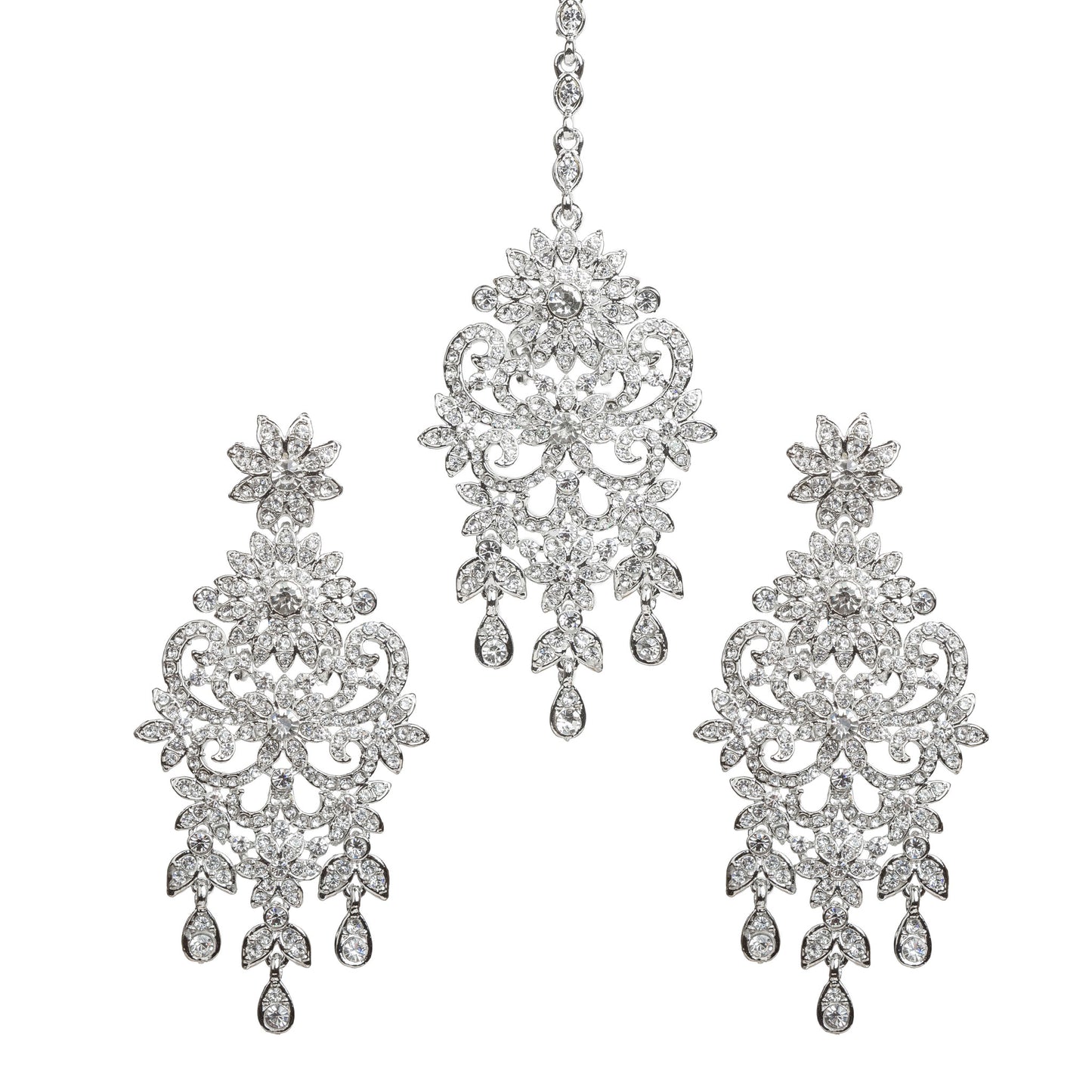 Bindhani silver-toned earrings and maang tikka set embellished with clear stones and sparkling crystal accents. The earrings feature a floral top, intricate leaf and scrollwork design with a central floral motif, and three dangling teardrop-shaped clear stone drops. The matching maang tikka showcases a coordinating floral design with detailed openwork, a central floral motif, and three dangling teardrop-shaped clear stone drops. Front view displayed on a white background.