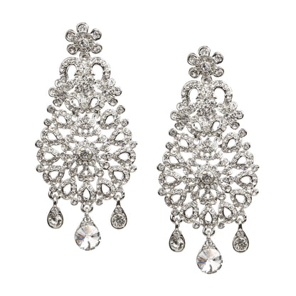 Bindhani silver-toned statement earrings embellished with clear stones and intricate floral filigree detailing. Each earring features a floral stud, an ornate openwork teardrop-shaped design with a sparkling central floral motif, and three dangling clear stone charms with a larger teardrop stone at the center. Front view displayed on a white background.